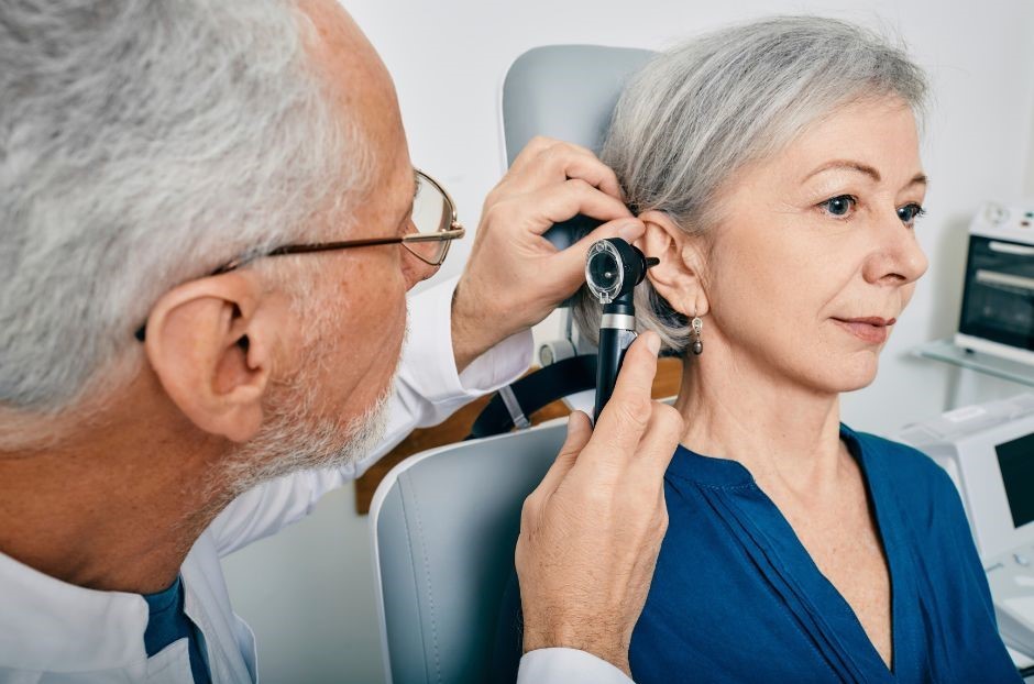Image of woman getting her ears syringed by a professional