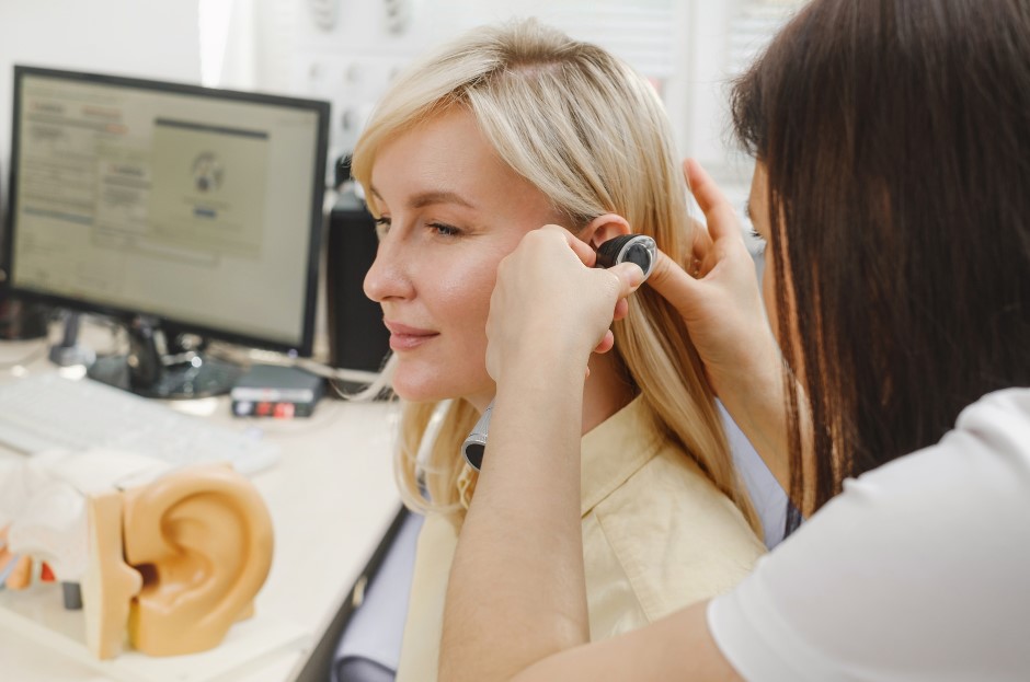 Ear care specialist looking at a patients ear